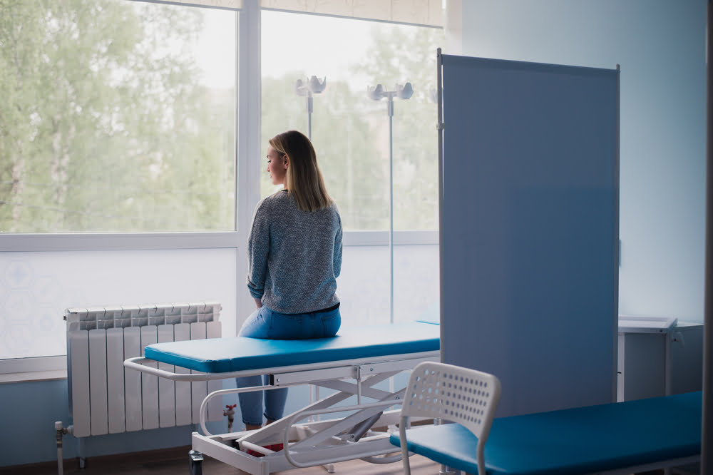 Woman sitting on hospital bed